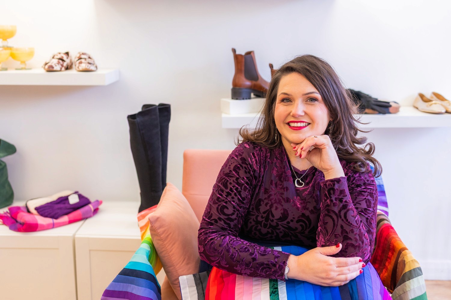 Lucy, smiling with her coloured drapes on her lap.