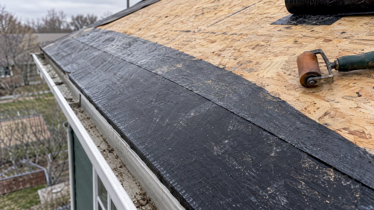 Self-adhered ice barrier installed along roof eave