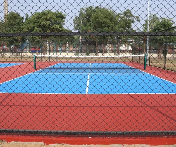 Sunlit modern living room with orange chair, plant.