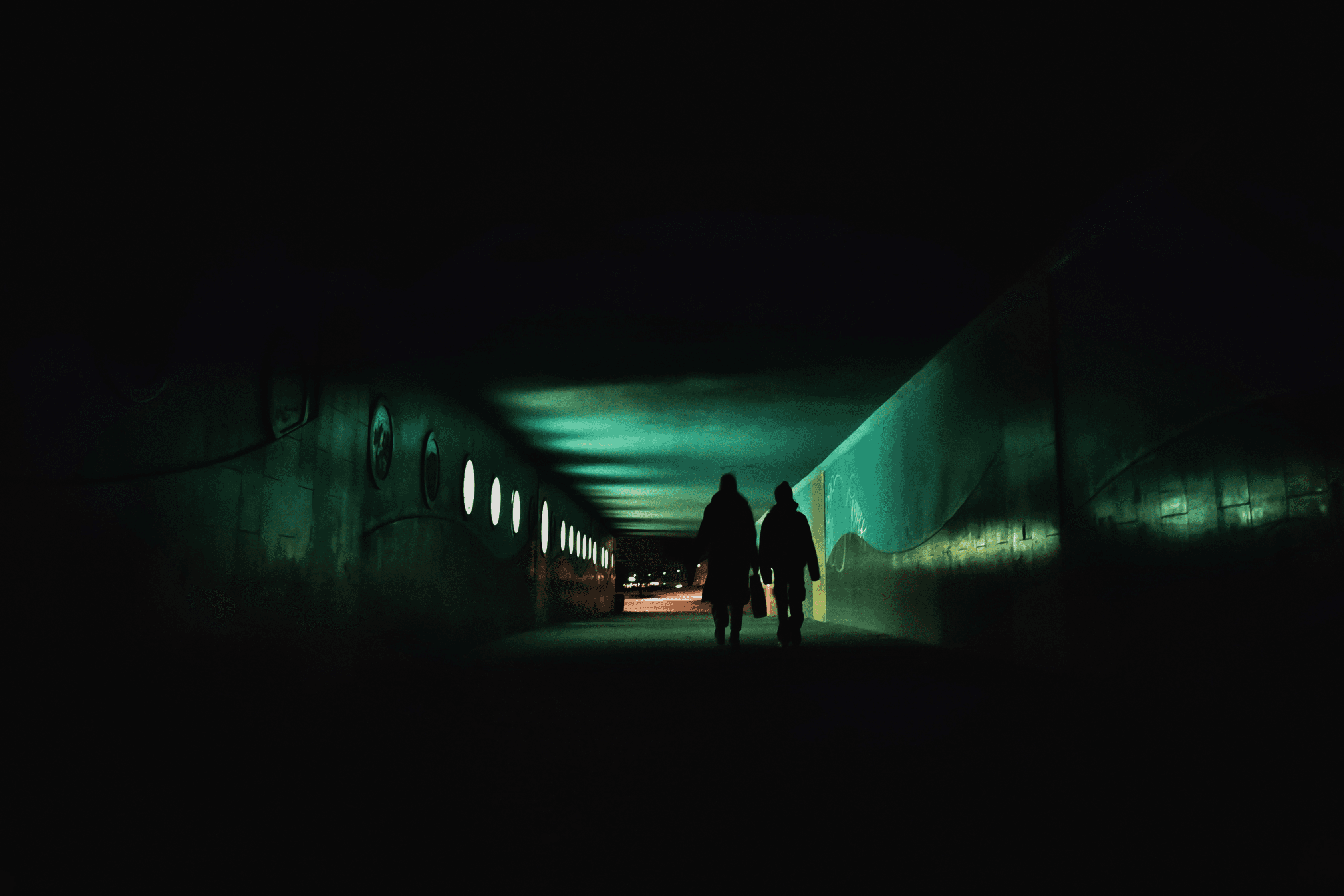 Person sitting on a ledge overlooking New York City skyline