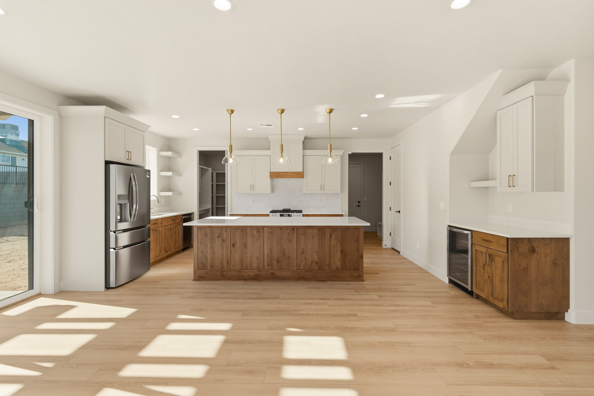 Kitchen at The View at Falcon Ridge in Hurricane, Utah, featuring medium-toned wood cabinets, white countertops, and a spacious layout.