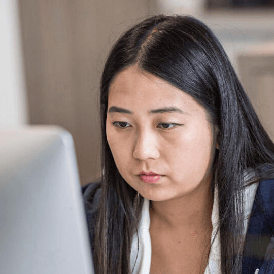 Female developer working at a large computer screen