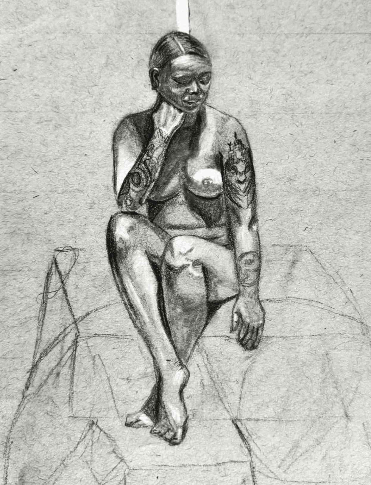 man wearing grey t-shirt standing in front of man sitting on chair