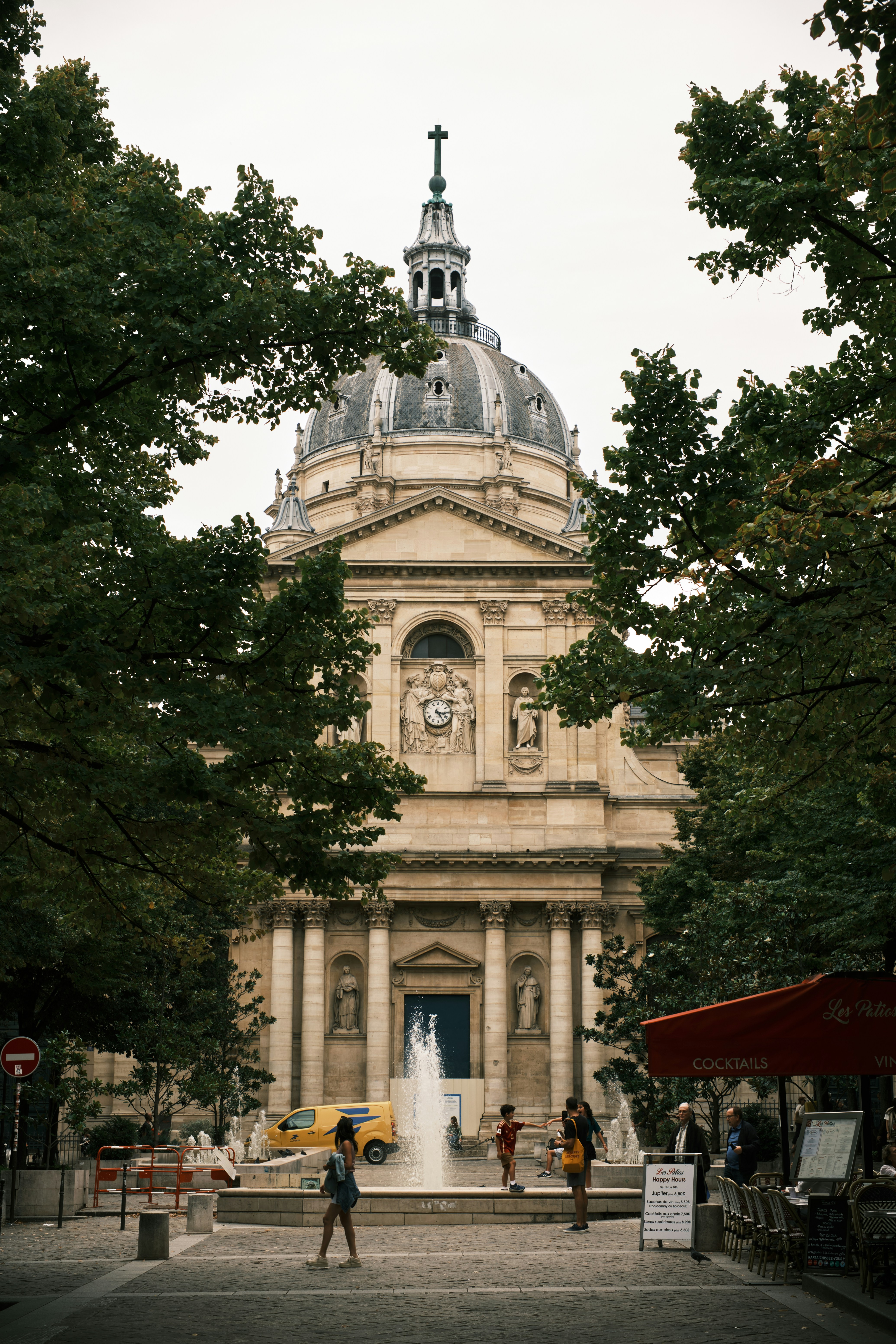 Ornate building with dome and fountain in foreground