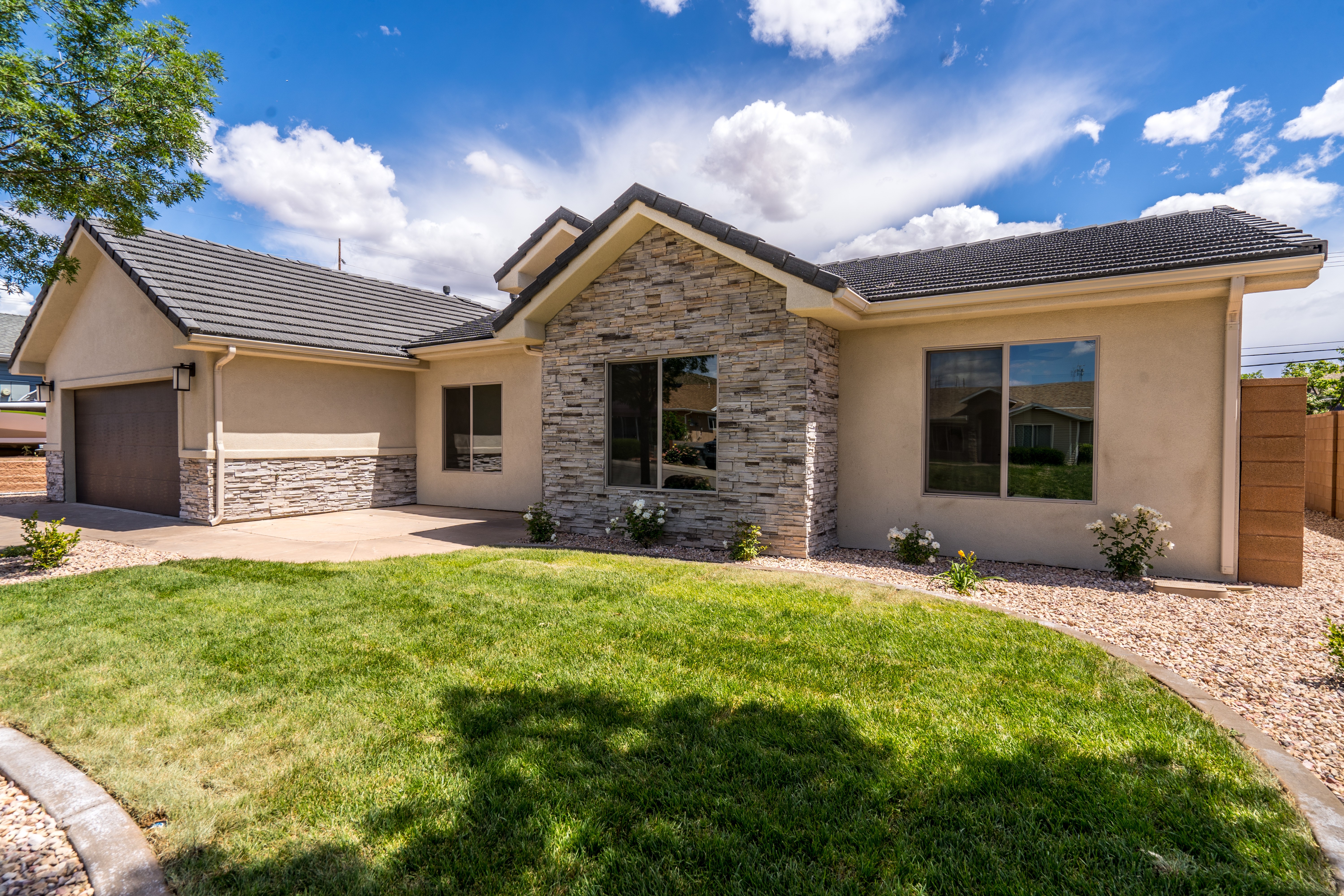 Front view of a Southern Utah remodel showcasing contemporary stone and stucco exterior.