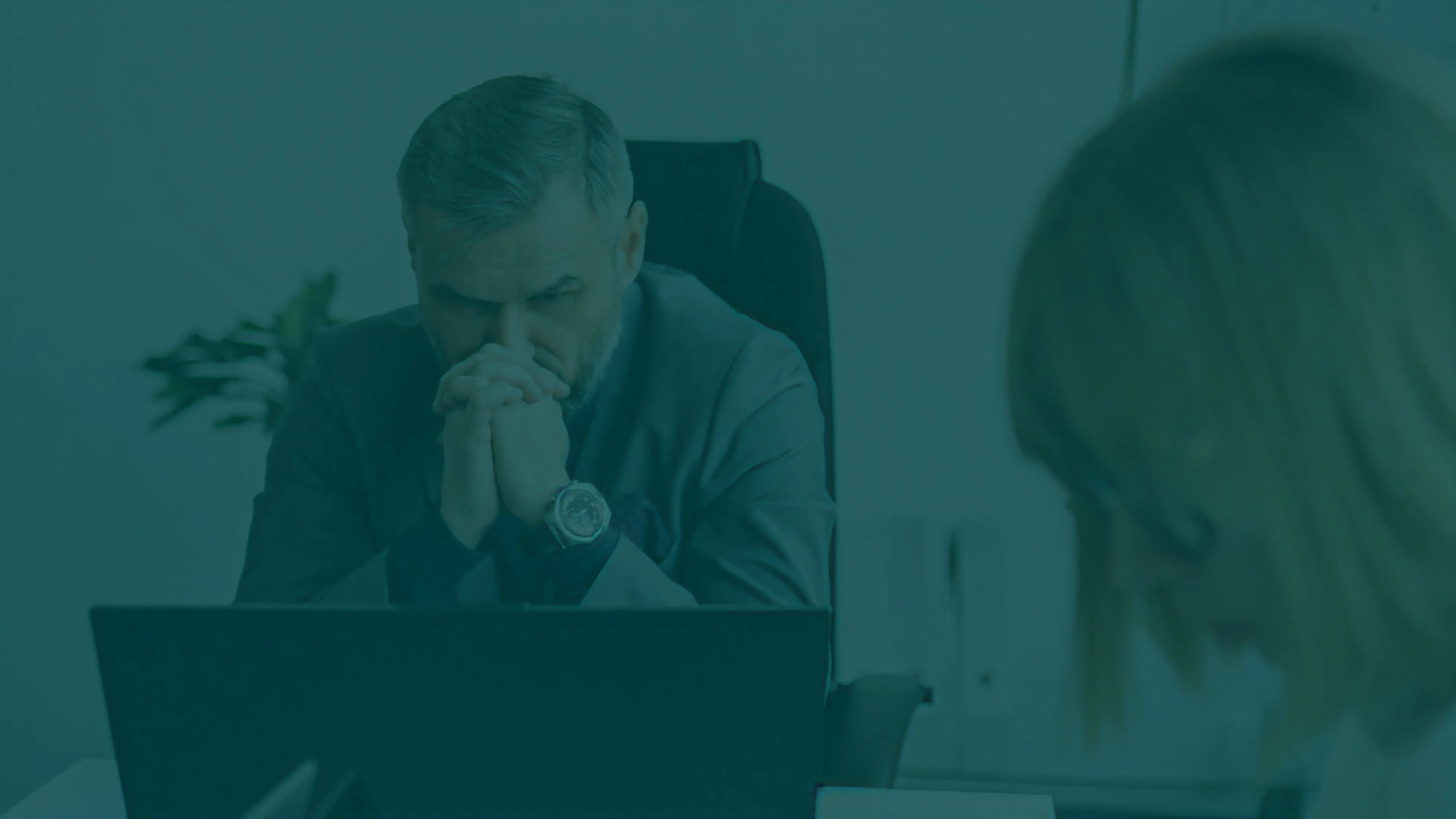 Fotografia conceitual desfocada de uma equipe de negócios analisando dados em um notebook, sobreposta por uma camada de cor azul da Fidúcia.