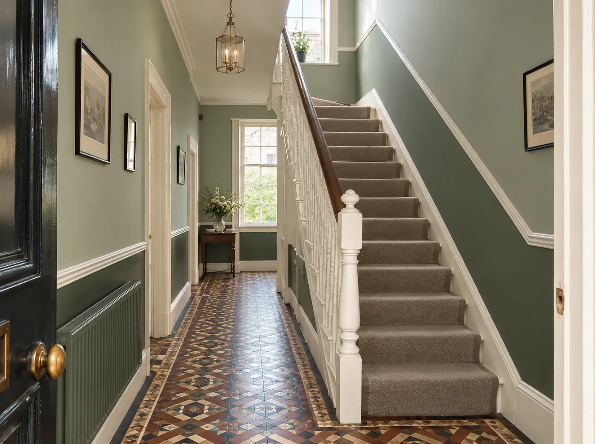 The same Victorian hallway after decorating: sage green walls, a darker green dado, crisp white woodwork and the tiled floor