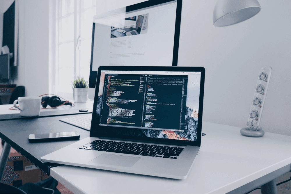 Laption on desk with codes on screen