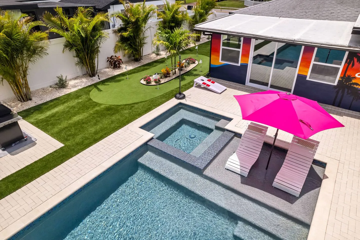 Aerial angled with pool, spa and pink umbrellas at Salty House, Bradenton, Florida