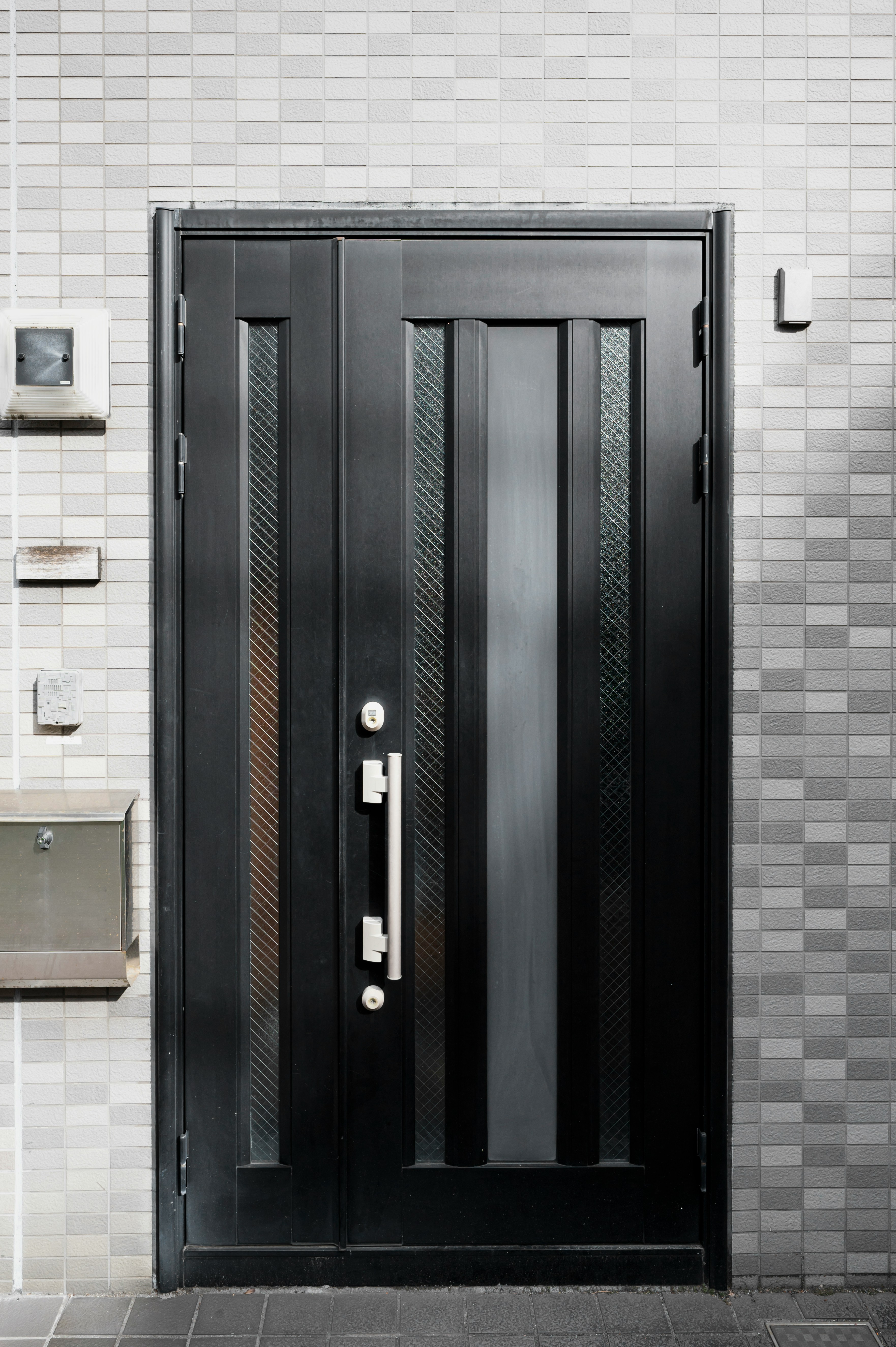 A modern black door with glass panels.