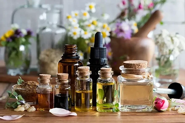 Various essential oil bottles and dried herbs.