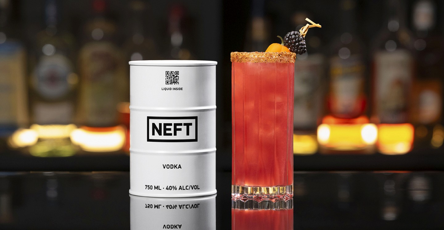 A NEFT Barrel and a glass of Blackberry Bridge on a bar counter.