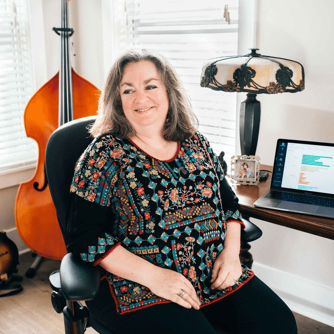 Becky Austen reviewing Lighthouse's trend dashboard. After a fruitful career at IBM, she planned a retirement filled with volunteer work and playing music. However, Becky was so compelled by Allies' mission that she switched gears and joined the Lighthouse team in 2019.