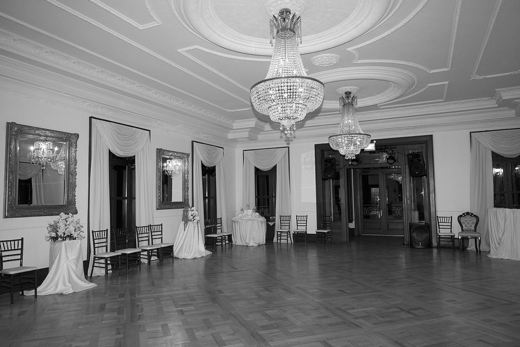 Ballroom with chandeliers and tables prepared for an elegant wedding reception