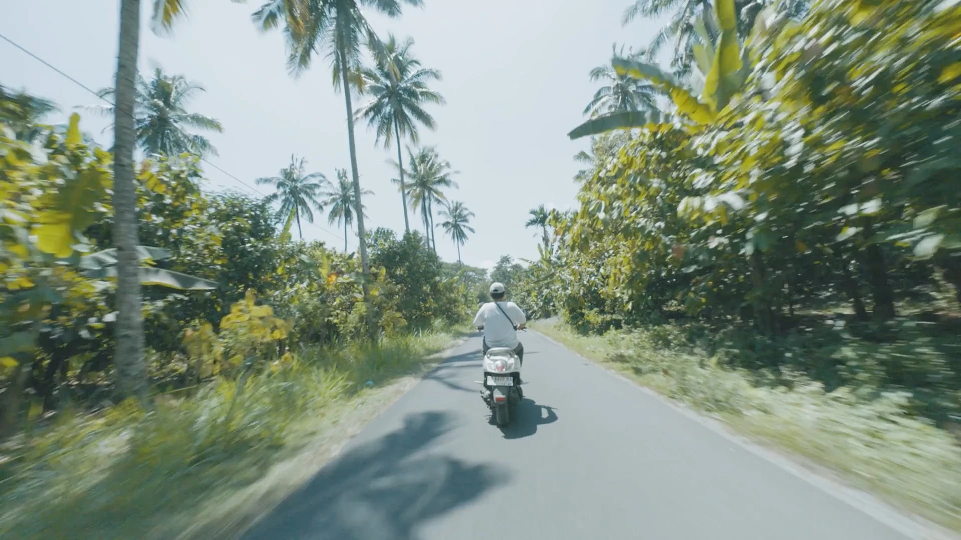 a young local drives his motorcycle in Lombok