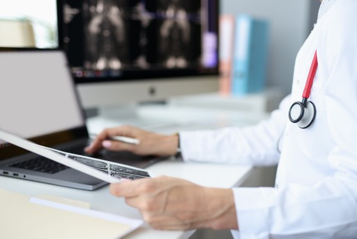 a glimpse into the hands of a doctor working on X-rays