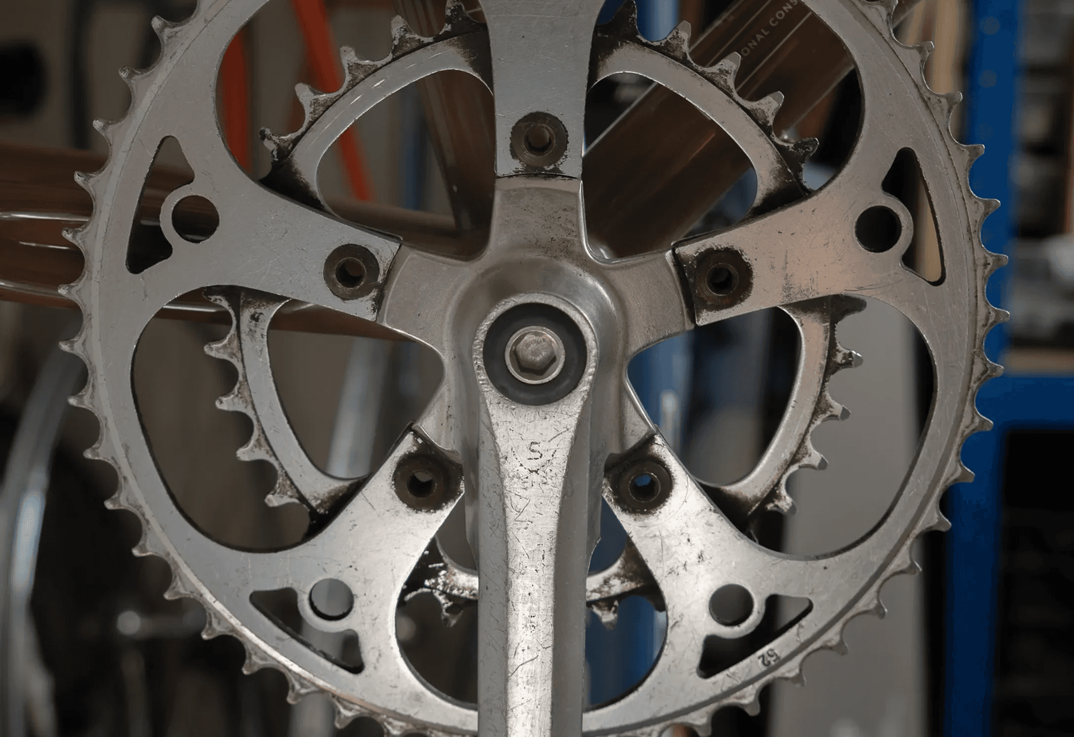 A close up of a person working on a bike crankset