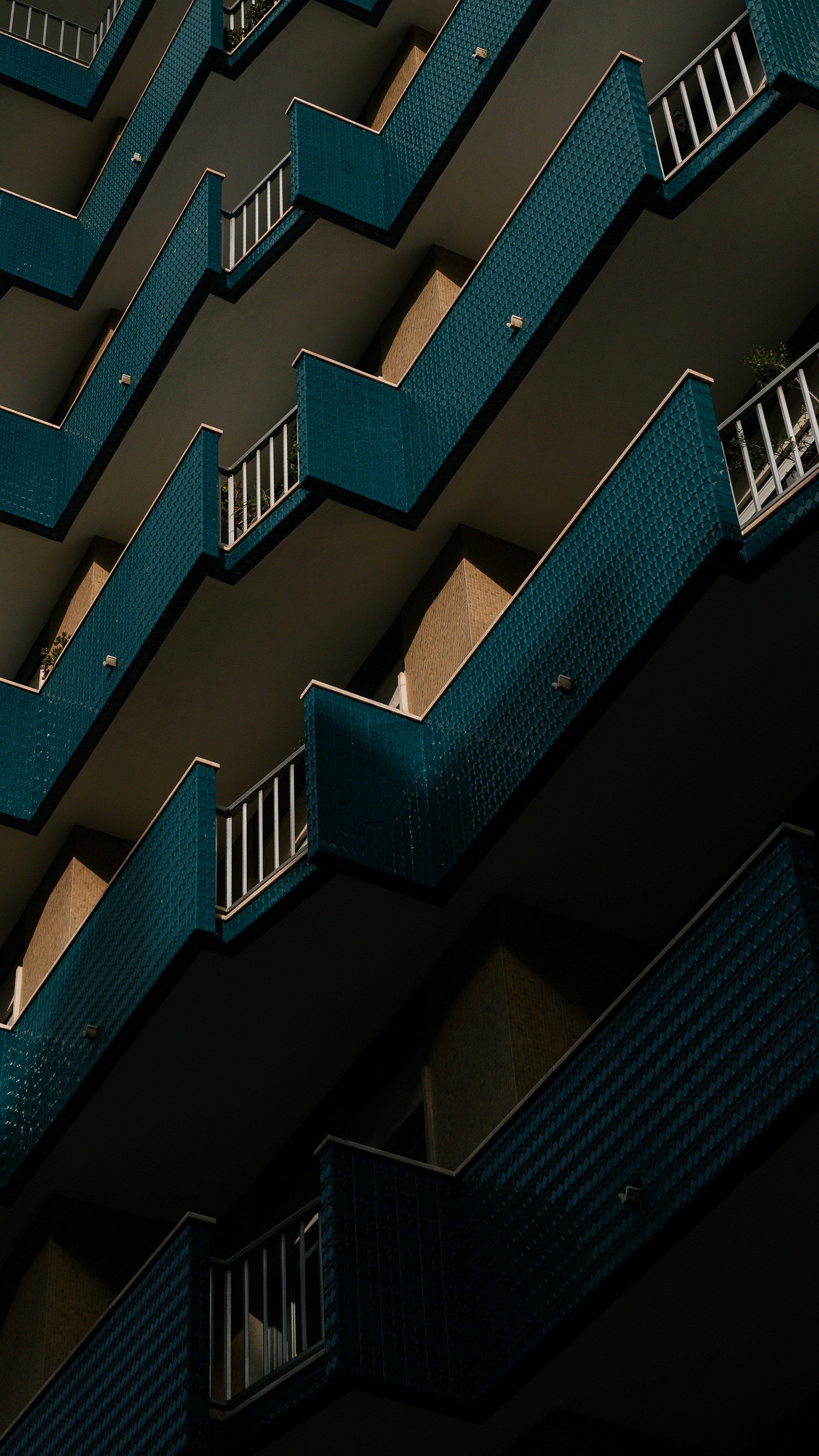 Modern building with repeating balconies and blue tile accents