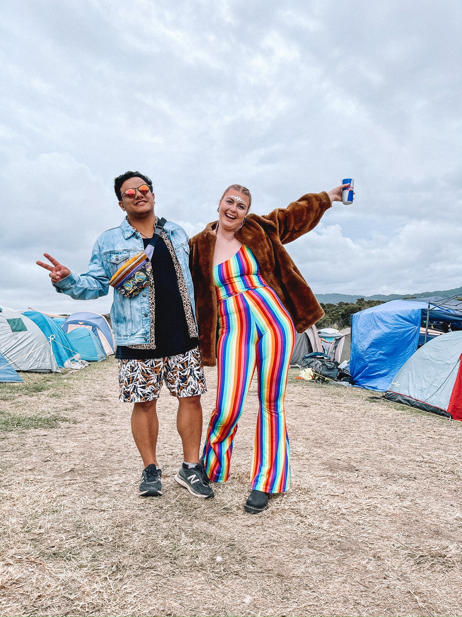 A close-up of two people holding hands, one wearing a denim jacket. The background is softly blurred, suggesting a tender, intimate moment in warm light.