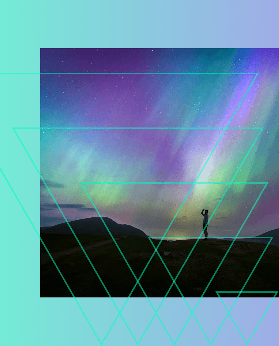 Person watching colorful aurora borealis lights in night sky.
