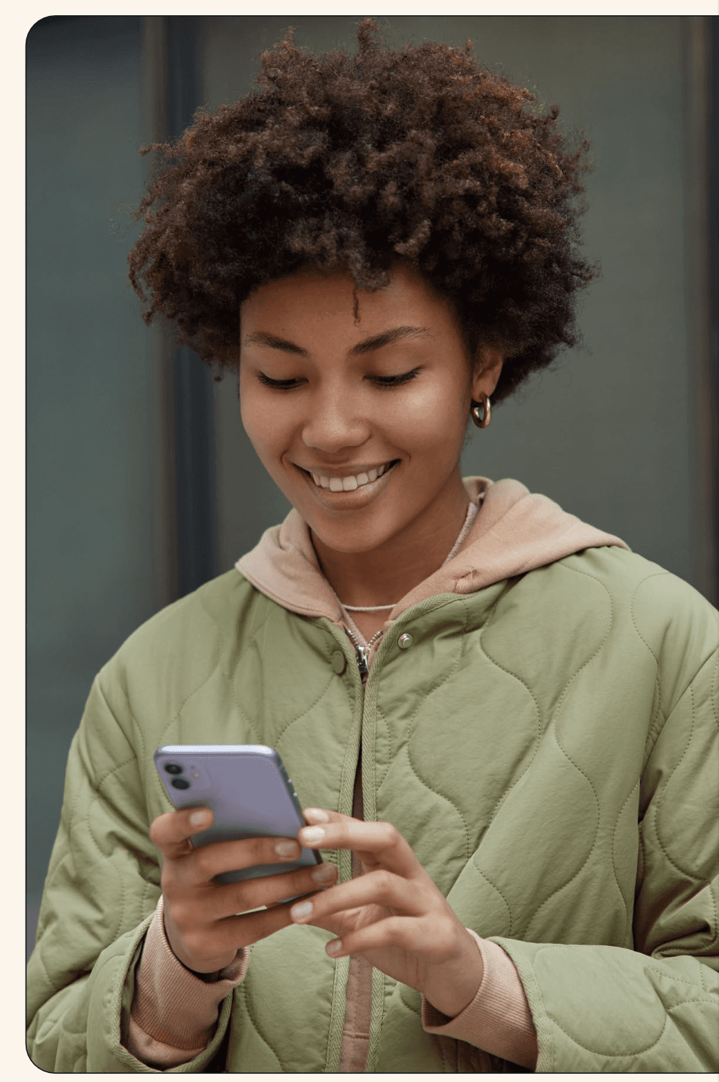 Man and woman standing together at a desk with a laptop and notebooks, smiling at the camera.