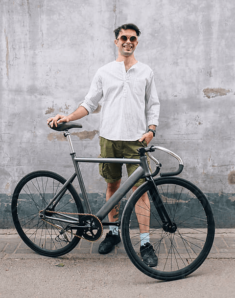 A happy City Cycles customer smiling beside the bike they rented.