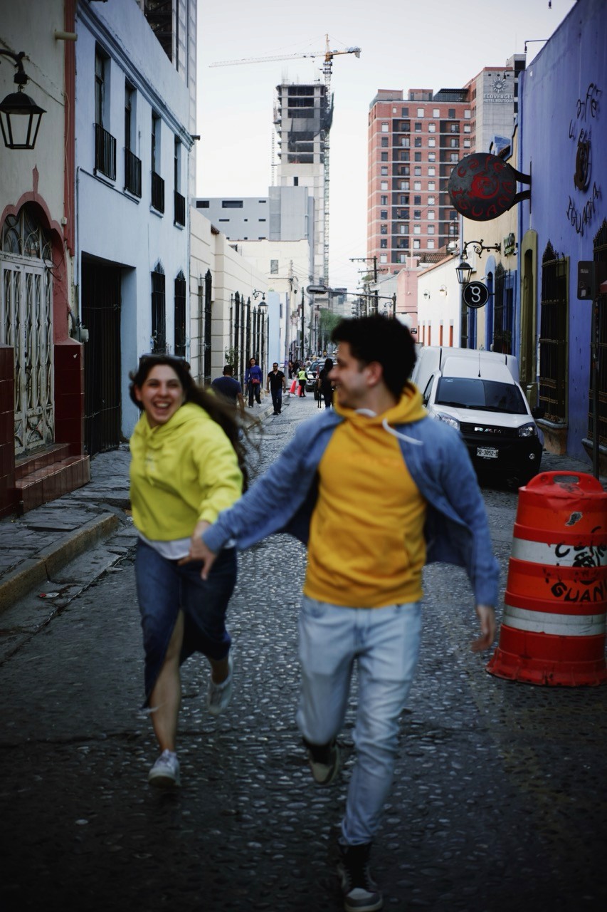 Person stand in front of a red sports oldtimer