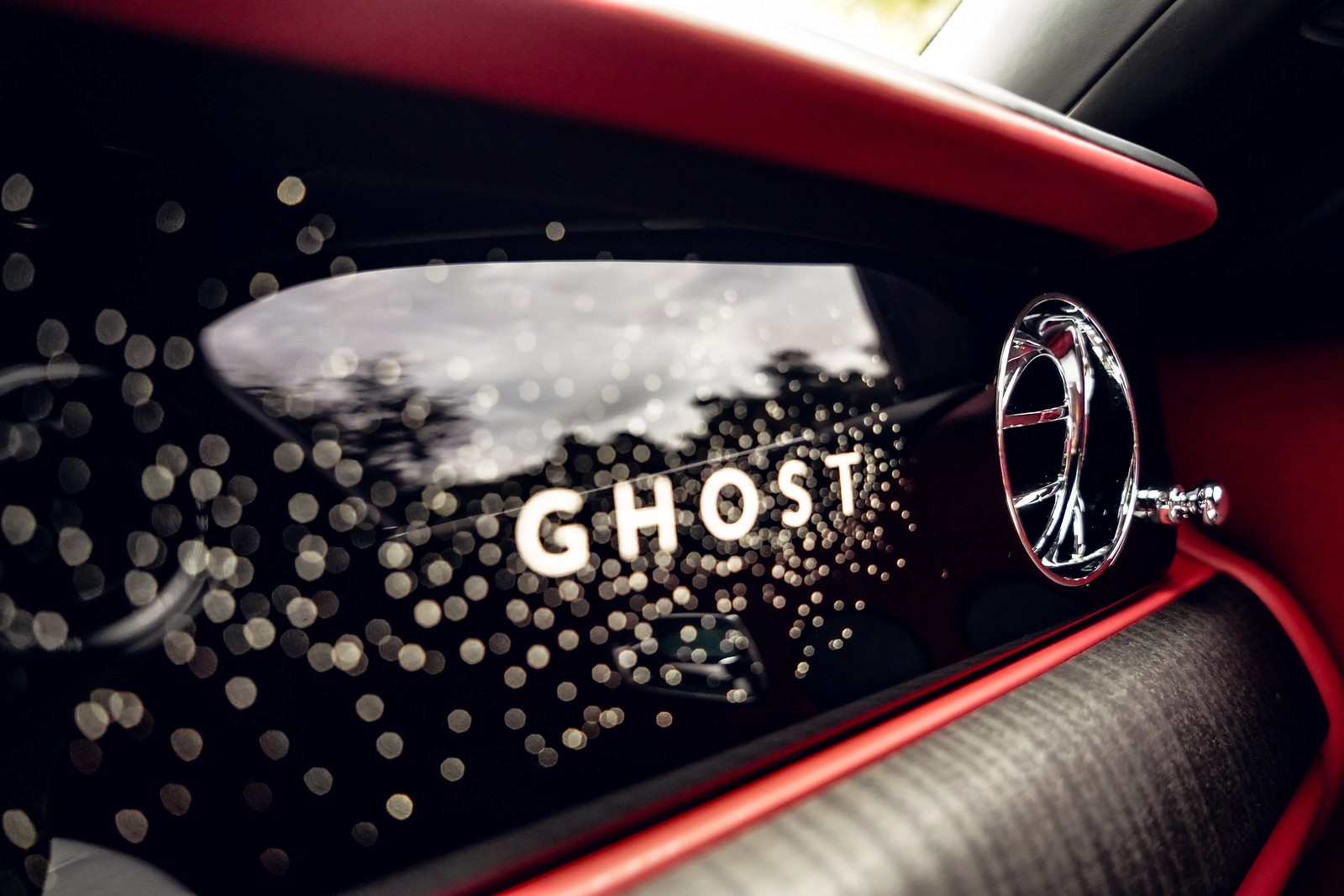 Close-up shot of the passenger dashboard showing the word "Ghost" and the starlight design.