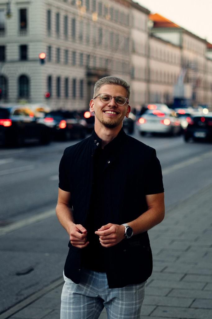 Portrait of a young man looking at the camera with a blurry background