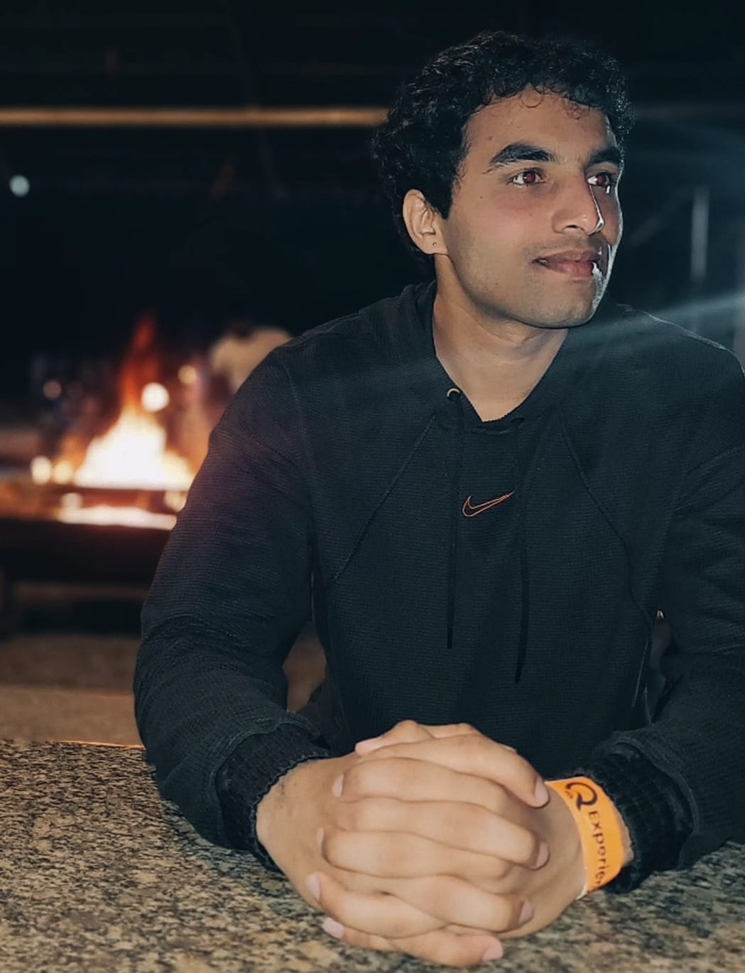 Close-up of a dark green leaf showing its textured surface and central vein against a muted background.