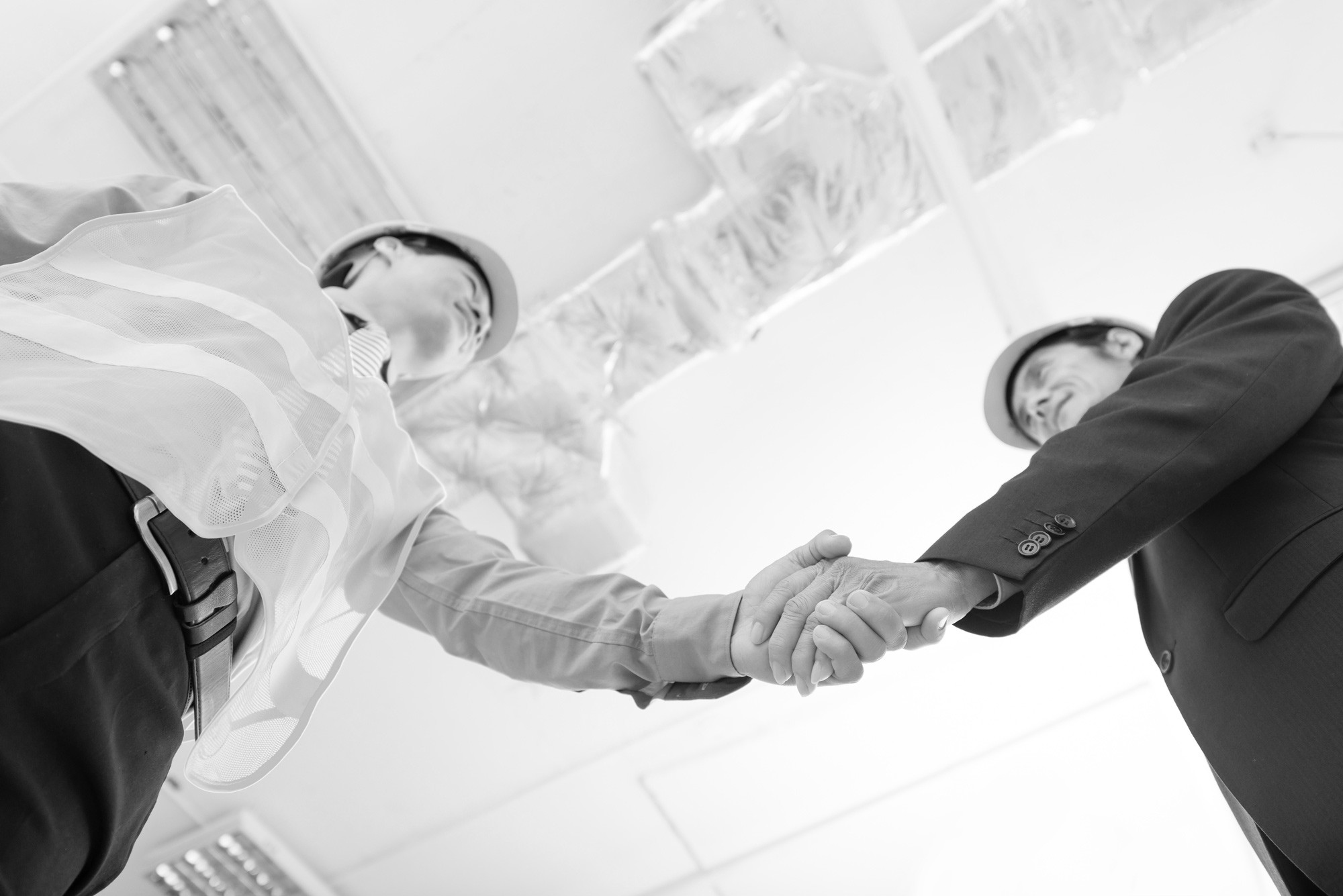 grayscale photo of rock formation on sea