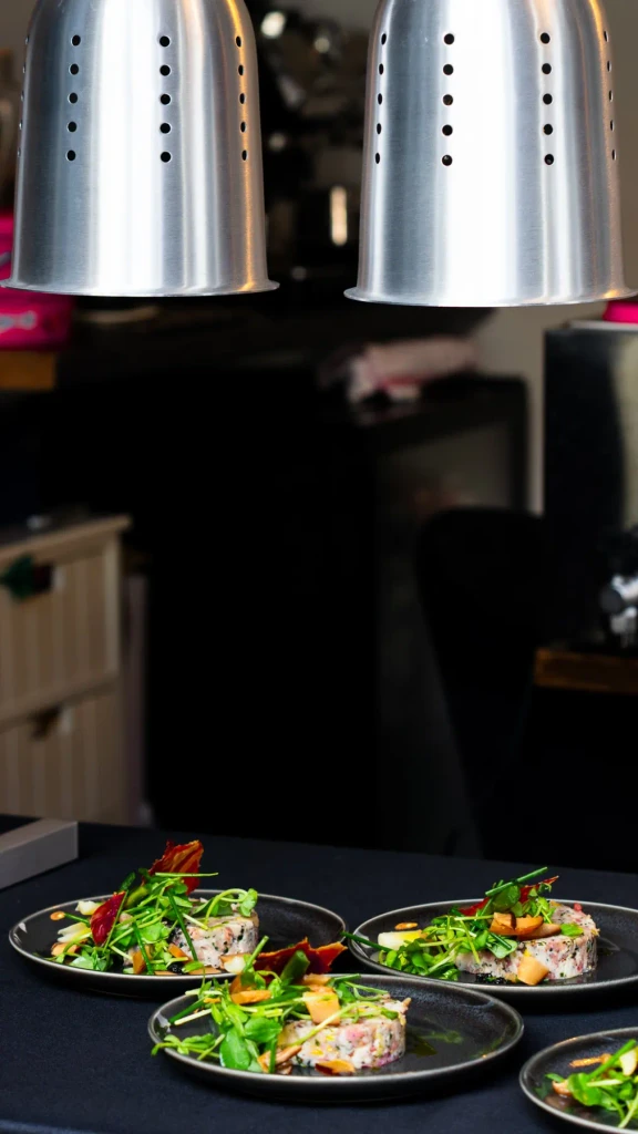 Starters waiting under the heat lamps on the pass