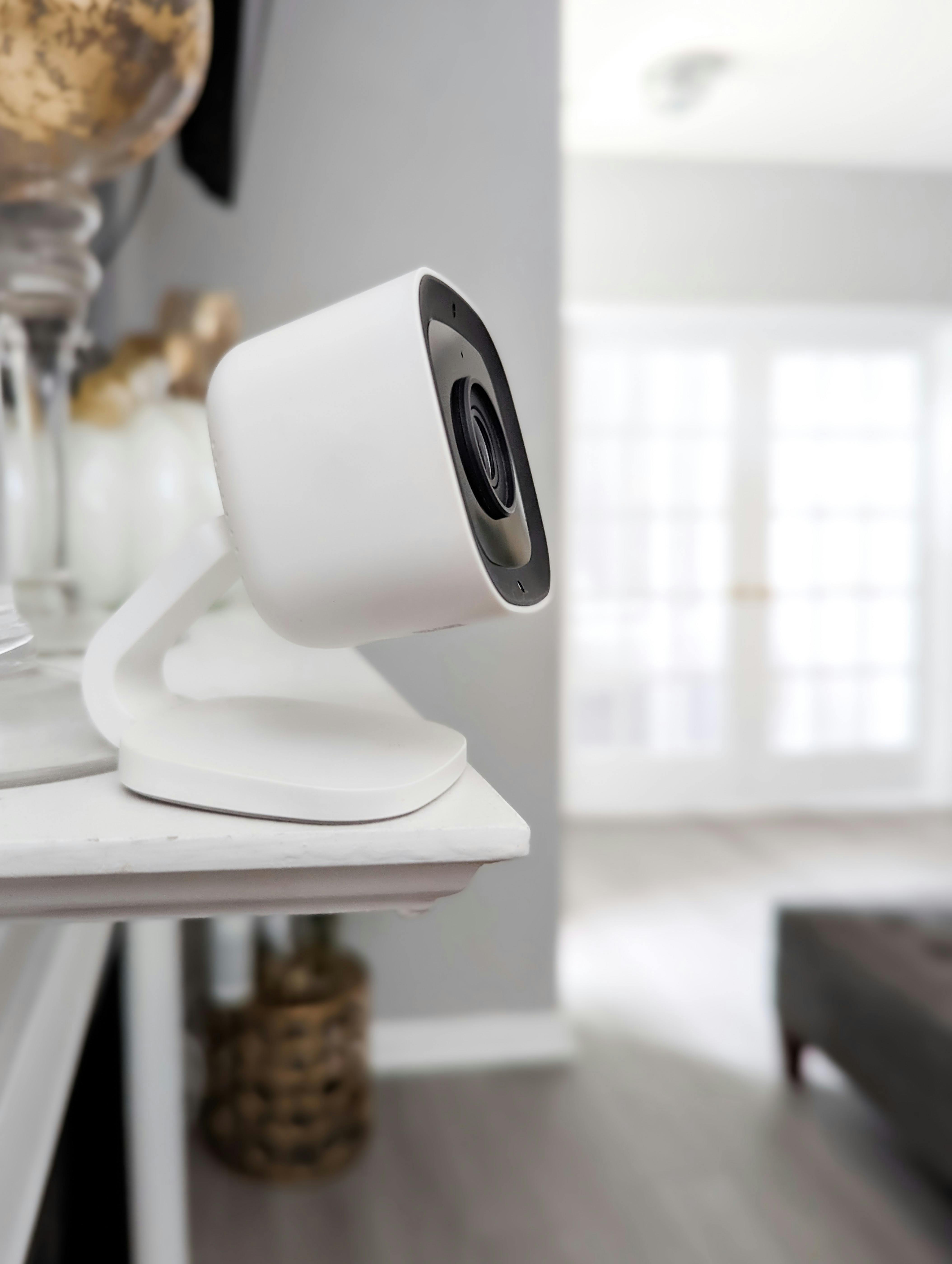 A portable home camera set up on a shelf