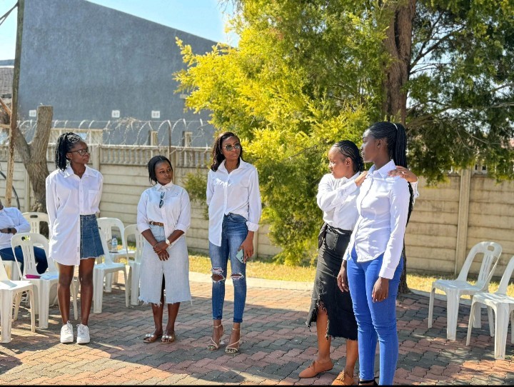 Close-up of vibrant purple flowers with droplets of water, creating a rich, textured background.