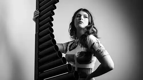 Sasha Berliner Holding her xylophone upright.