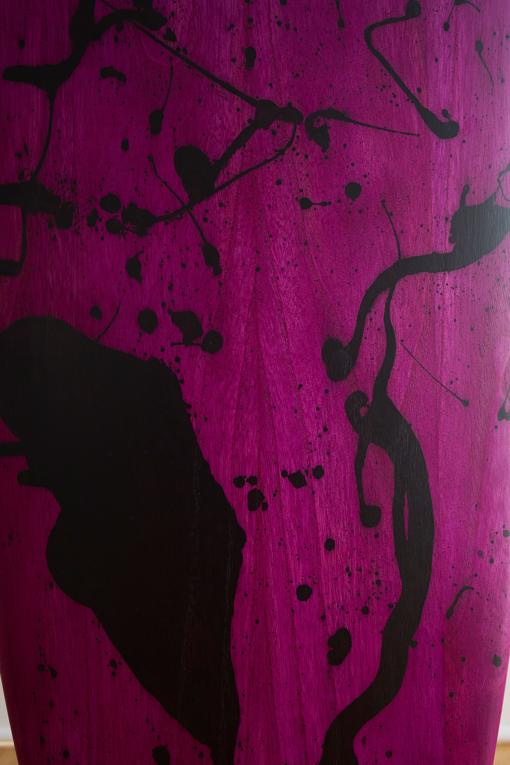 Splashed black wood stain surfboard