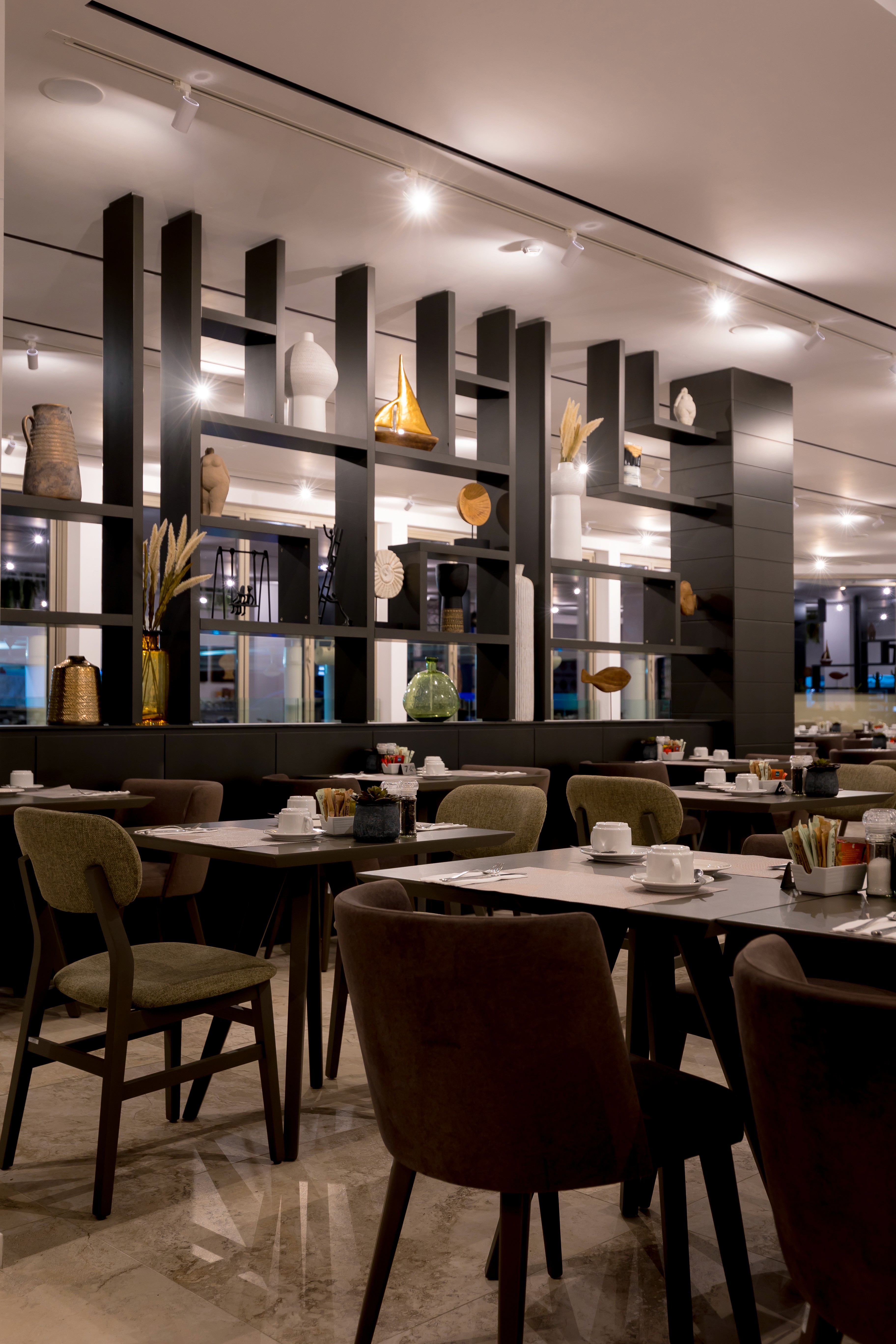 Geometric black timber shelving used as an acoustic filter in a large social space by topos design studio