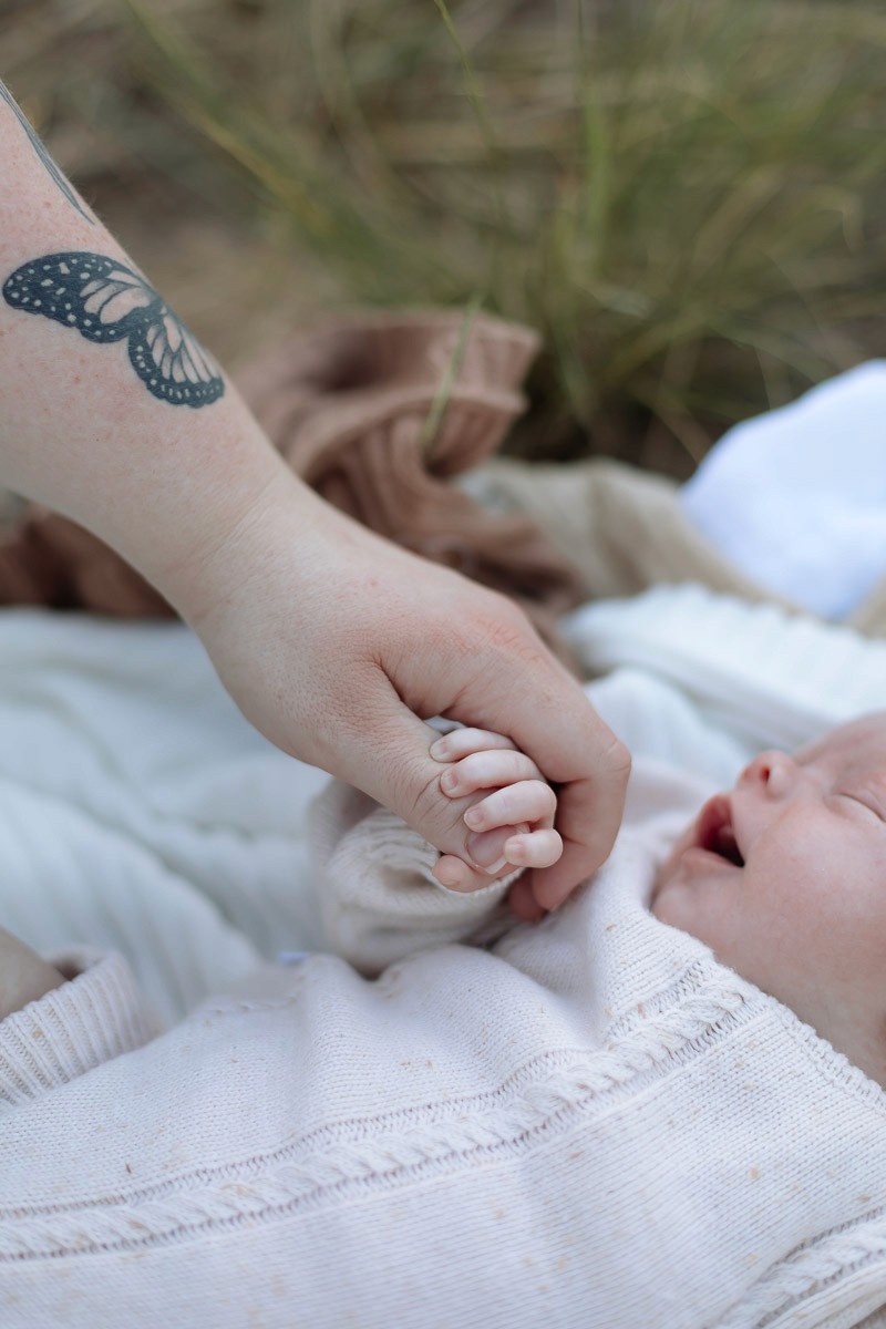 Close-up detail of newborn hands during newborn session in Mackay