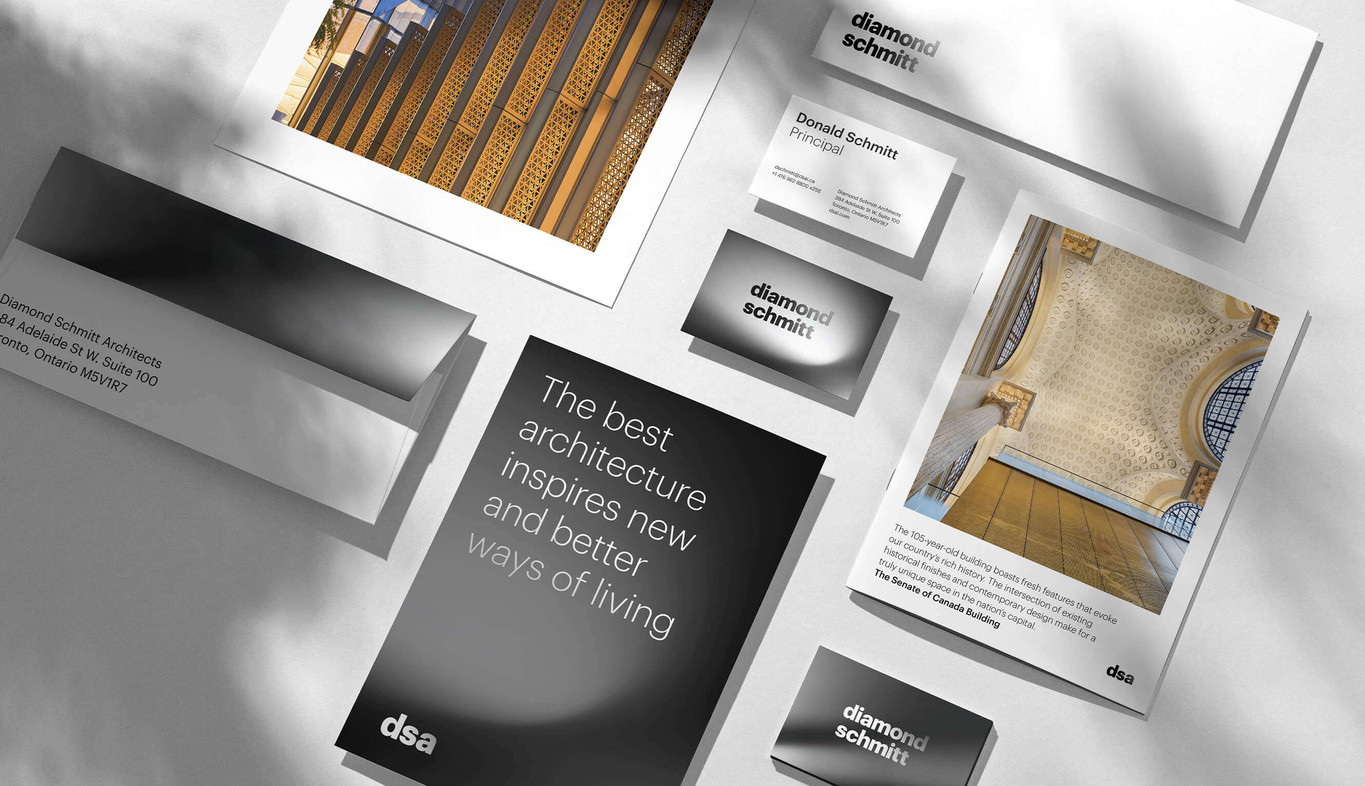 An aerial view of branded stationery, including business cards, envelopes, and posters.