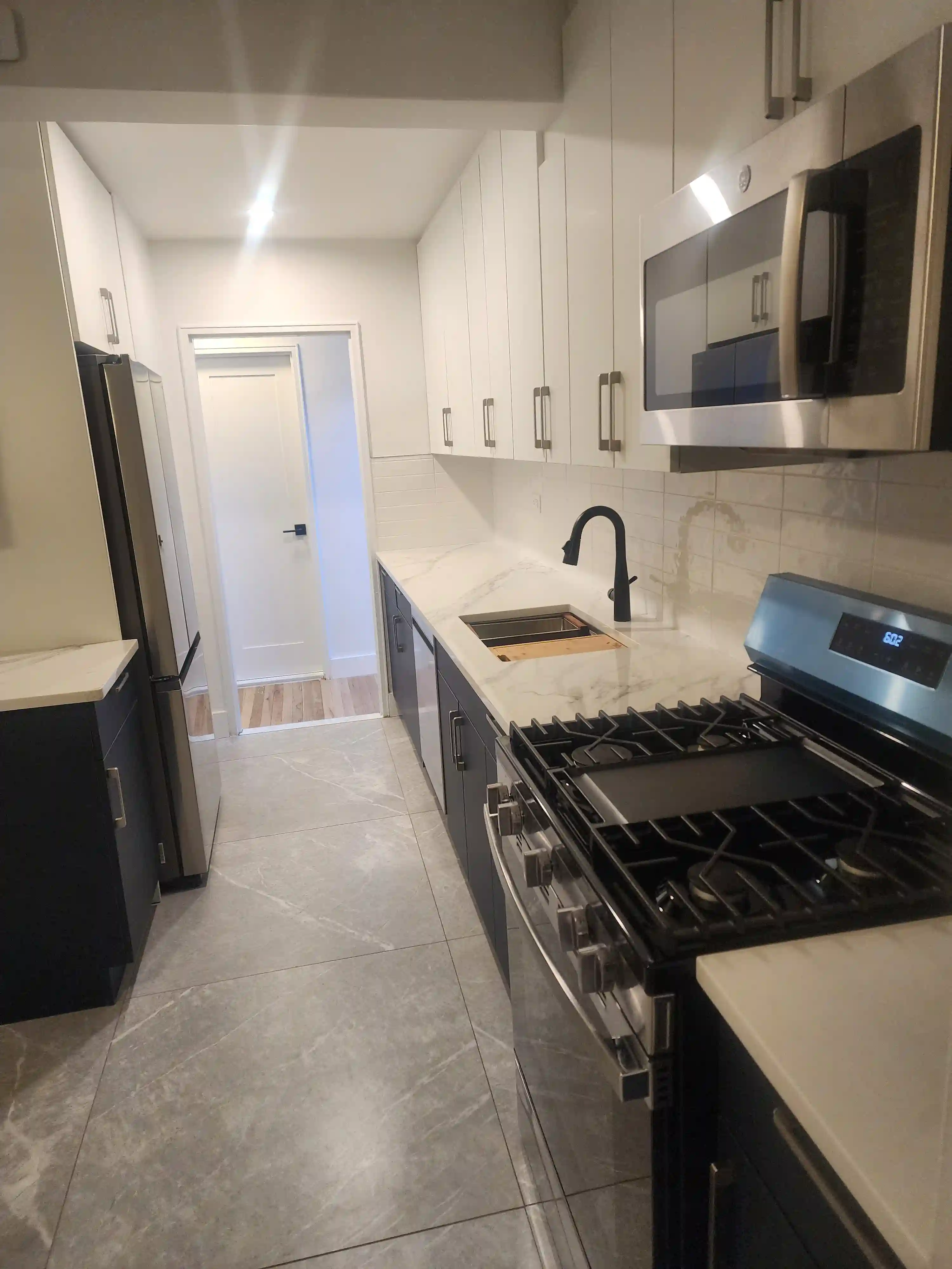 Luxury Trex composite deck stairs with picture framing, recessed lighting, and Transcend railings in Queens, NYC