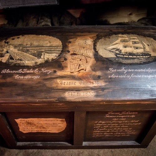 A wooden chest with Jeanie Johnston 1847 - 1855 etched into the lid