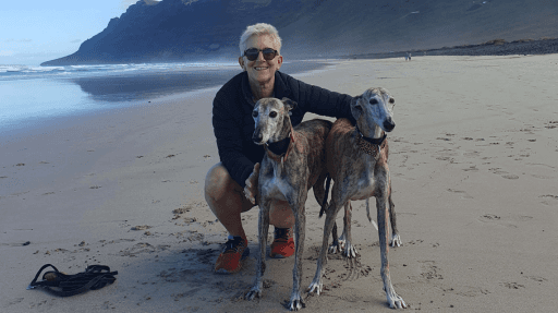 Image of Verity Harrison, illustrator from Inky Thinking on the beach with her dogs