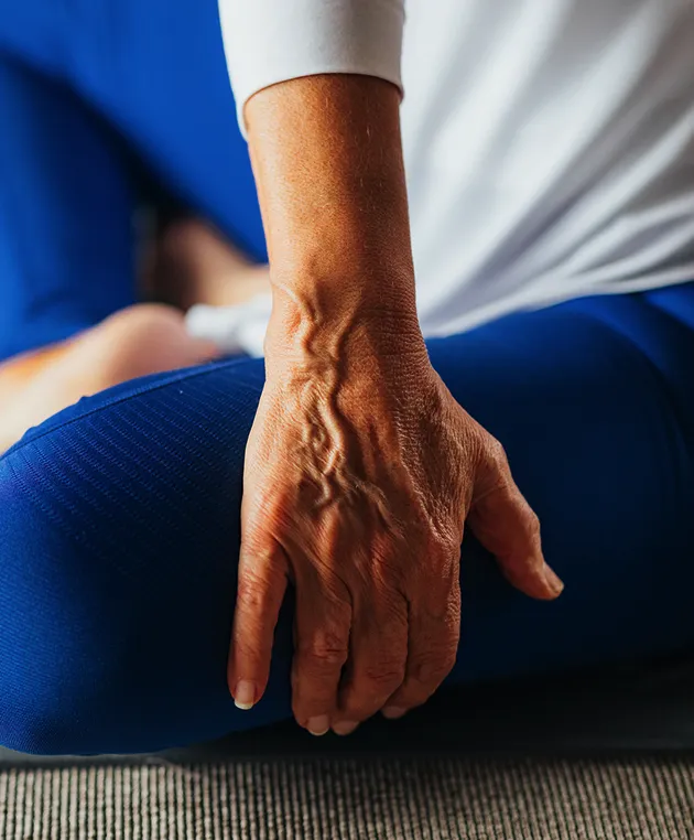 Older woman stretching, representing mobility and healthy aging in women.