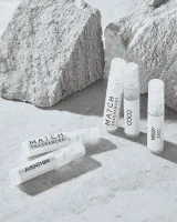 Motocross rider performing a wheelie in a desert