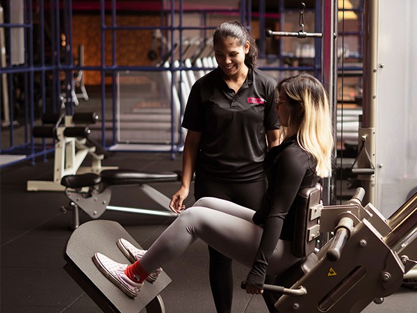 personal training in kuala lumpur, woman using a foam roll for recovery with a female coach in a women only private training room