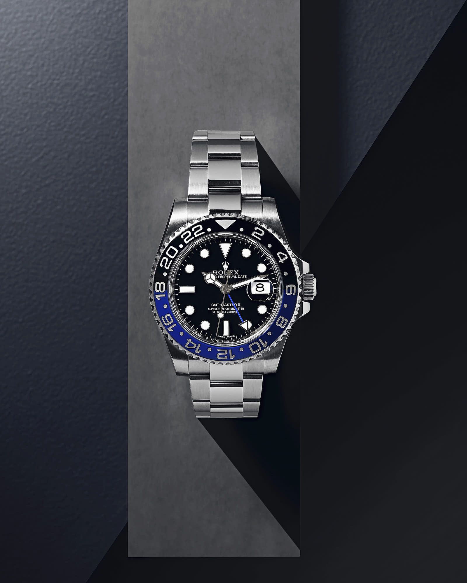 Luxury Rolex GMT-Master II watch with stainless steel bracelet and black-blue bezel.