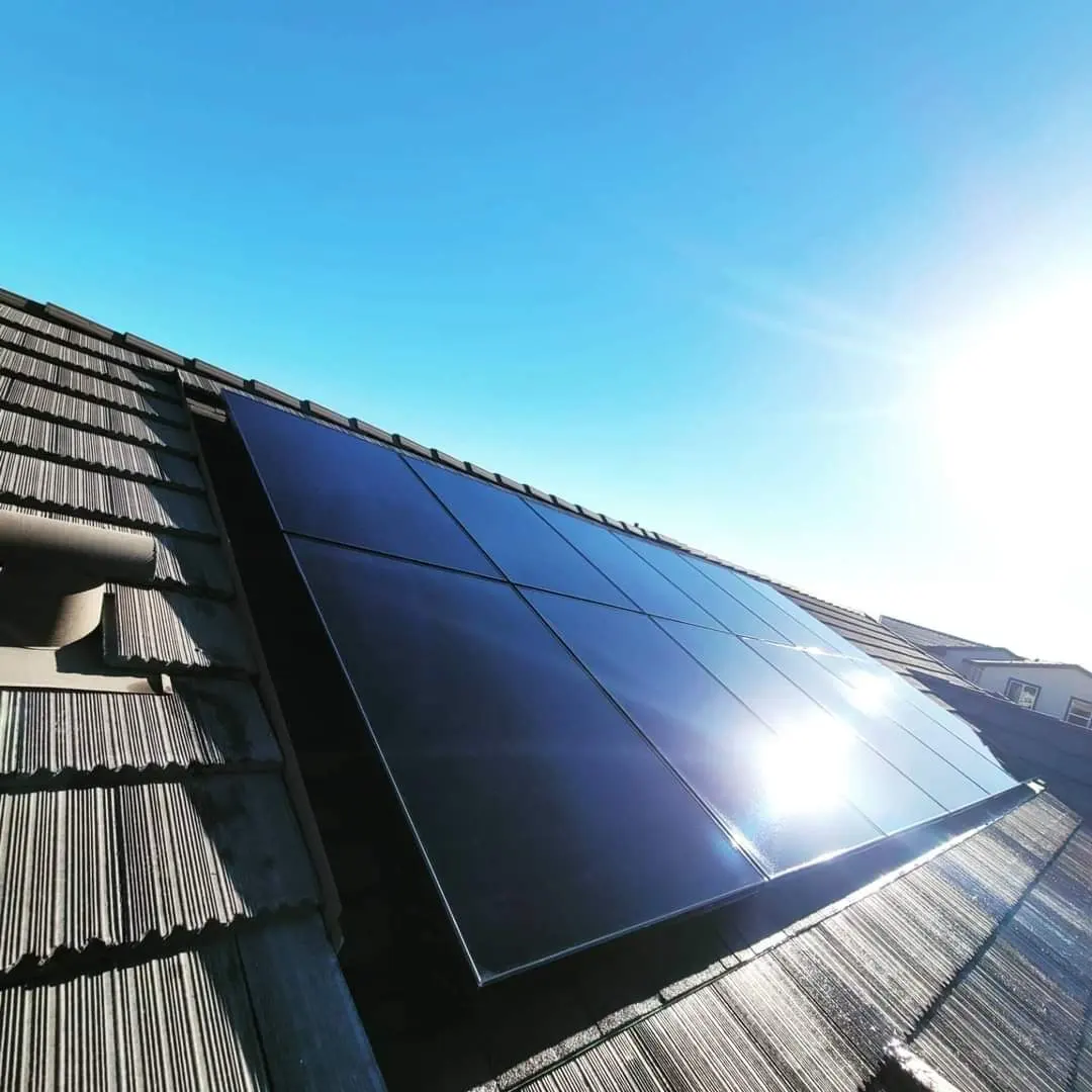 Row of solar panels with sun flare | Premier Solar Service