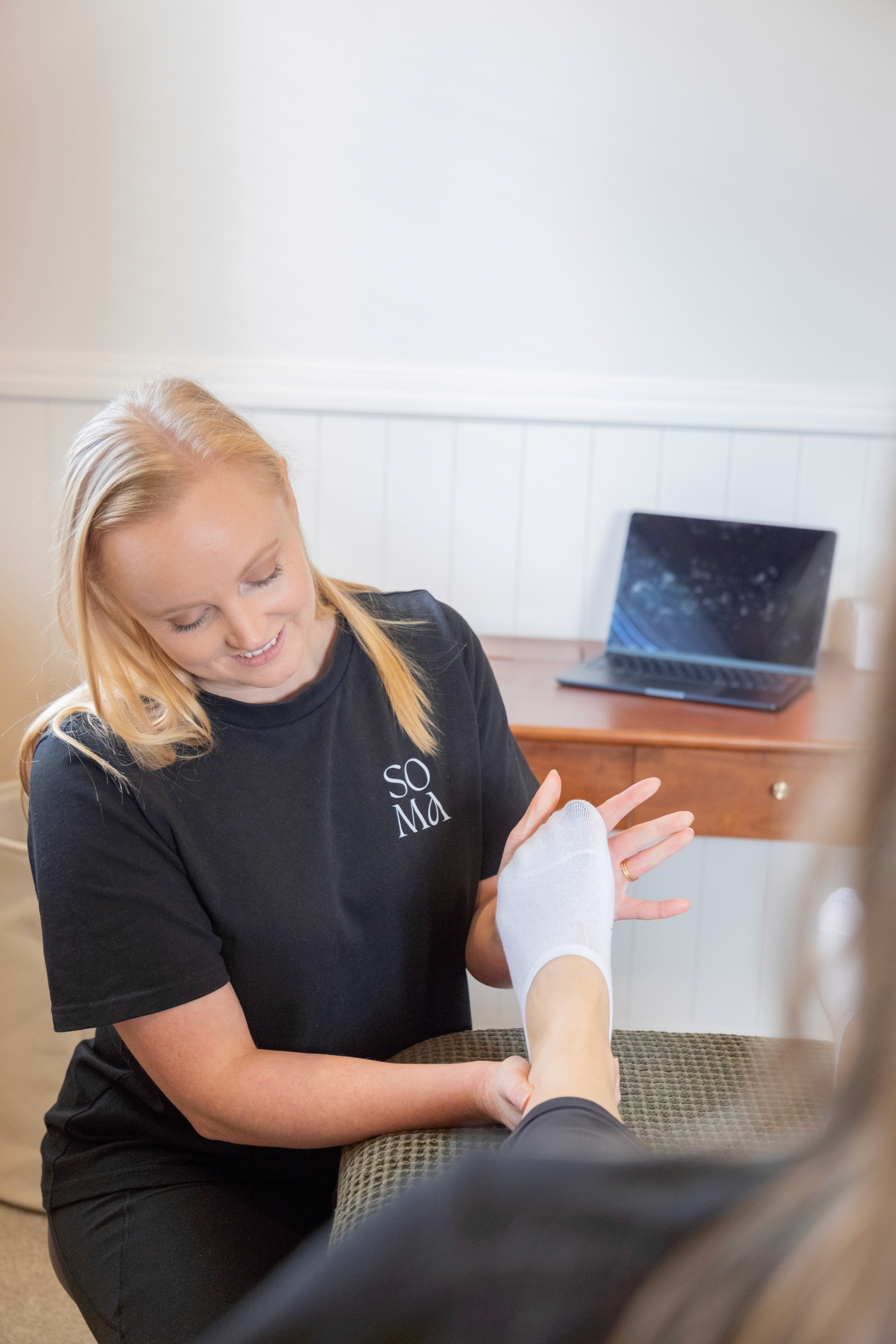 Physio assessing foot