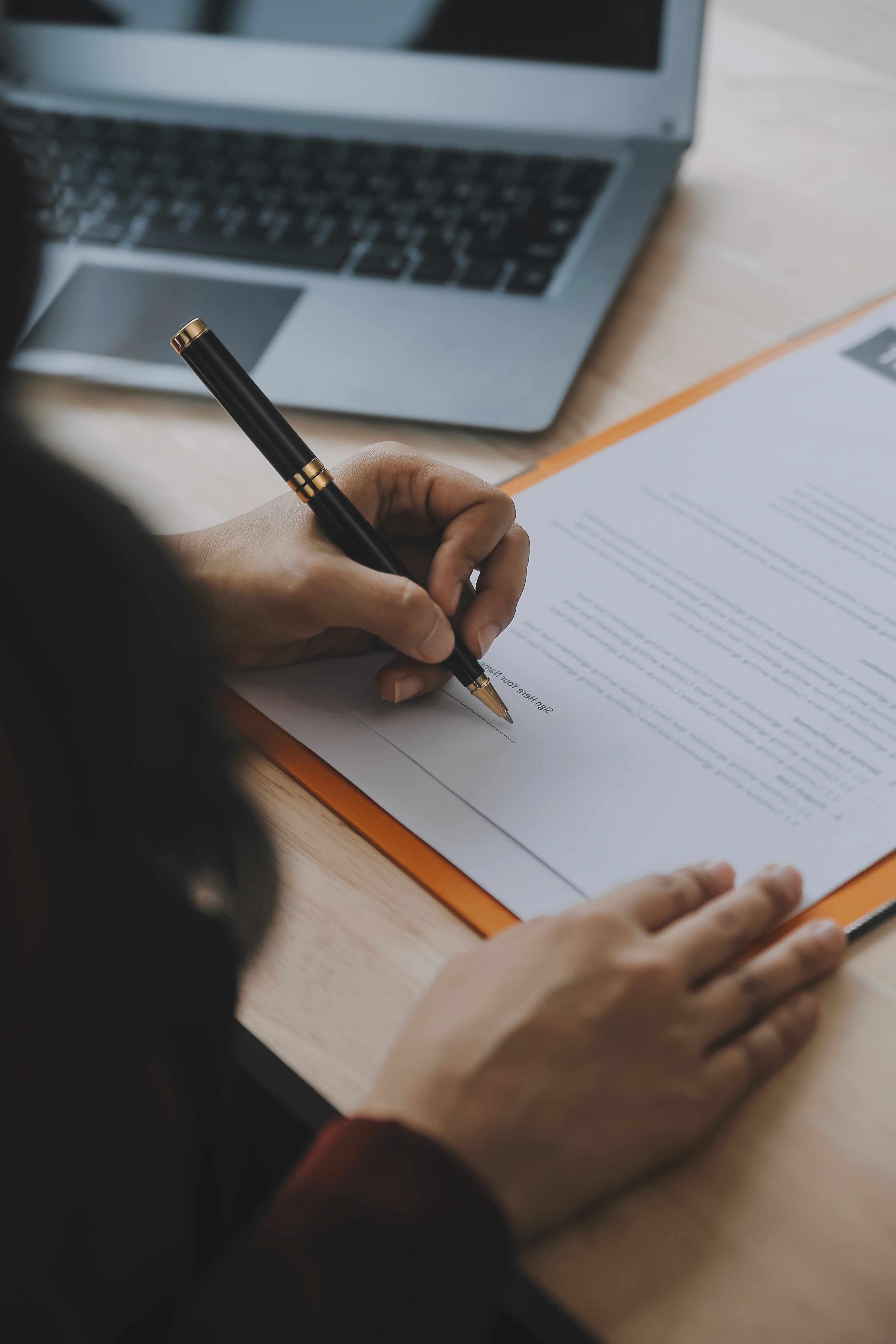 Woman handing over a document in a modern office.