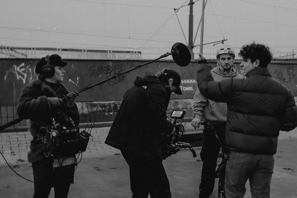 Three people in ski gear in a film studio